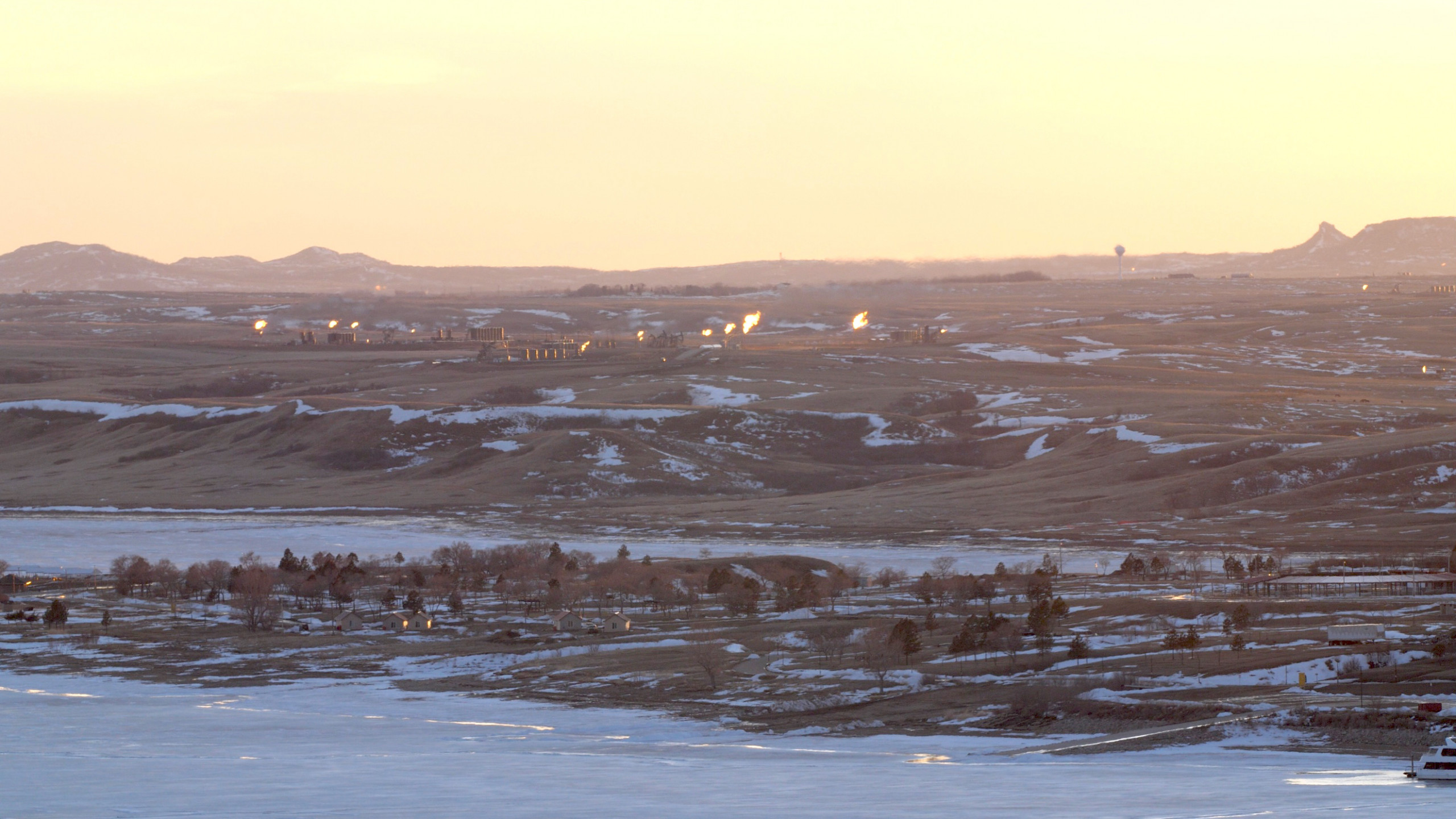 Natural gas flaring on the lands of the Mandan, Hidatsa and Arikara Nations. As seen from the bluffs overlooking the Missouri River across from Four Bears Village, MHA Nation, March 2019.  Photo: Angela Anderson
